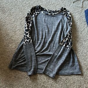 Long sleeve dressy shirt has leopard print on it. Never worn